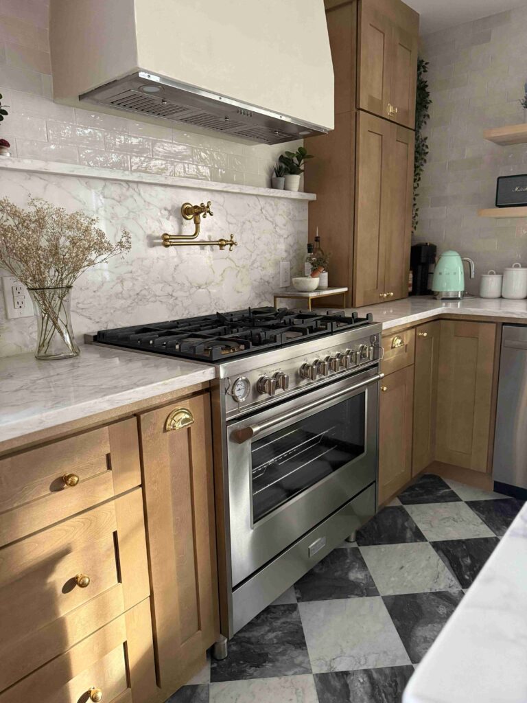Stainless steel Verona freestanding gas range in warm wood and marble kitchen 